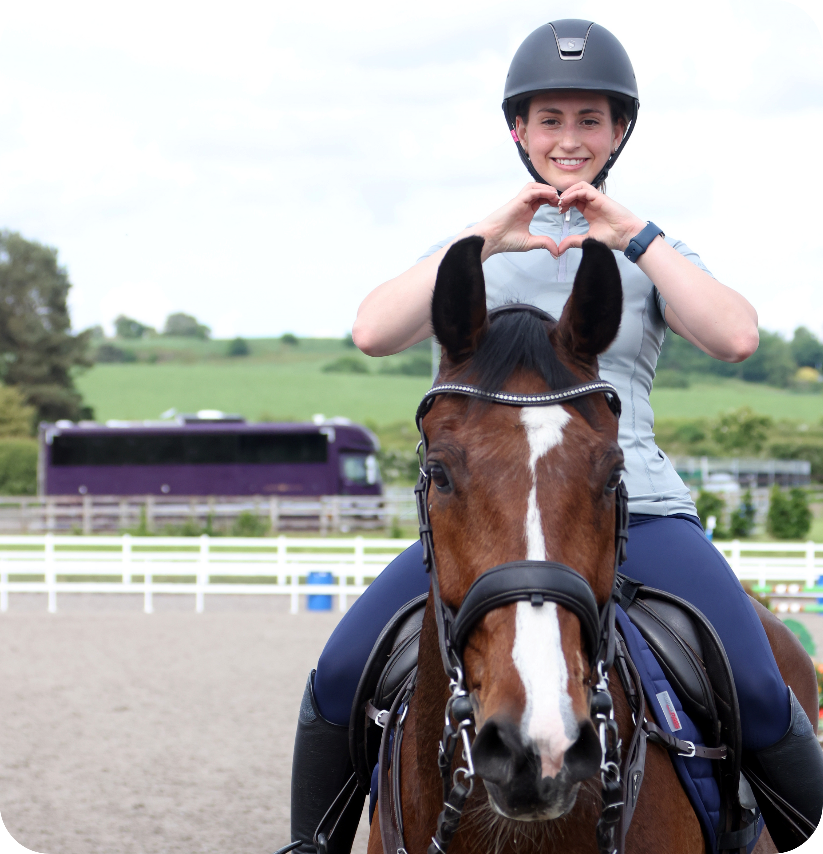 woman on a horse doing the heart sign 
